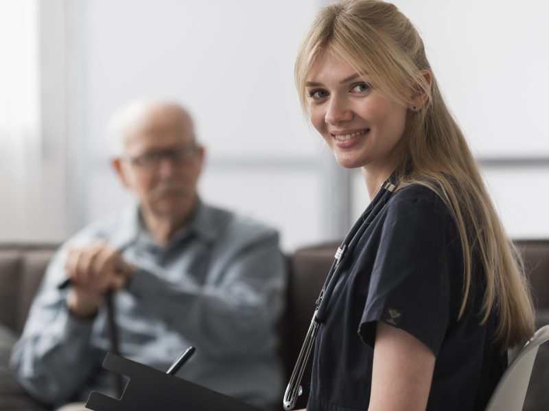 smiley-female-nurse-posing-with-man-nursing-home
